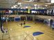 Spacious indoor basketball court with hardwood floors, hoops, and ample lighting for sports and recreational activities at 4218 W Palace Station Rd, New River, AZ 85087