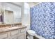 Bathroom featuring granite vanity, and a bathtub with blue patterned shower curtain at 4218 W Palace Station Rd, New River, AZ 85087
