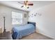 Bright bedroom featuring a ceiling fan, carpet, and a sunny window at 4218 W Palace Station Rd, New River, AZ 85087