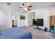 Spacious bedroom featuring a ceiling fan, neutral carpet, and an en suite bathroom at 4218 W Palace Station Rd, New River, AZ 85087