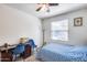 Cozy bedroom with a desk, ceiling fan and natural light from the window at 4218 W Palace Station Rd, New River, AZ 85087