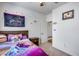Bedroom featuring a bed with a wooden frame, neutral carpet, and colorful wall decor at 4218 W Palace Station Rd, New River, AZ 85087