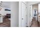 Hallway featuring wood-look tile flooring and white doors leading to a bathroom and the main living area at 4218 W Palace Station Rd, New River, AZ 85087