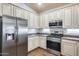 Well-lit kitchen featuring granite countertops, stainless steel appliances, and ample cabinet space at 4218 W Palace Station Rd, New River, AZ 85087