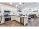 Stylish kitchen open to the living area features granite countertops, stainless appliances, and wood flooring at 4218 W Palace Station Rd, New River, AZ 85087