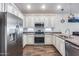 Modern kitchen with stainless steel appliances, granite countertops, and white cabinetry at 4218 W Palace Station Rd, New River, AZ 85087