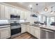 Bright kitchen with granite countertops, stainless steel appliances, and pendant lighting at 4218 W Palace Station Rd, New River, AZ 85087