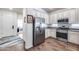 Open kitchen design featuring stainless steel refrigerator, granite countertops, and wooden-look flooring at 4218 W Palace Station Rd, New River, AZ 85087