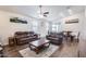 Inviting living room features wood-look tile flooring, a ceiling fan, and sliding glass doors to the backyard at 4218 W Palace Station Rd, New River, AZ 85087