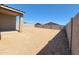 View of the backyard featuring a dirt lot surrounded by block fencing at 4256 W Lisa Ln, San Tan Valley, AZ 85144