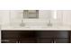 Close-up of a bathroom vanity featuring double sinks and dark wooden cabinets at 4256 W Lisa Ln, San Tan Valley, AZ 85144