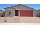 Charming single-story home with a red garage door and a low maintenance desert landscape at 4256 W Lisa Ln, San Tan Valley, AZ 85144