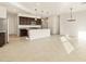 Open kitchen with island, stainless steel appliances and modern lighting fixtures, perfect for entertaining at 4256 W Lisa Ln, San Tan Valley, AZ 85144