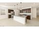 Bright kitchen features stainless steel appliances, granite countertops, and a center island with pendant lighting at 4256 W Lisa Ln, San Tan Valley, AZ 85144