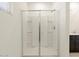 Modern bathroom shower featuring sliding glass door and convenient built-in shelving at 4256 W Lisa Ln, San Tan Valley, AZ 85144