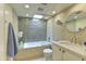 Bright bathroom with skylight features penny tile details, a shower-over-tub and modern fixtures at 4411 N 40Th N St # 37, Phoenix, AZ 85018