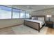 Calm bedroom with large windows, a brick accent wall, and neutral decor at 4411 N 40Th N St # 37, Phoenix, AZ 85018