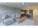 Open concept living room and kitchen area with modern finishes and a large comfortable sofa at 4411 N 40Th N St # 37, Phoenix, AZ 85018