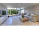 Bright living room with glass doors opening to a private patio and an exposed brick wall at 4411 N 40Th N St # 37, Phoenix, AZ 85018