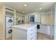 Spacious walk-in closet features custom shelving, drawers, a central island, and laundry machines at 4411 N 40Th N St # 37, Phoenix, AZ 85018