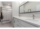 Beautiful bathroom featuring double sinks, a large mirror, and a tiled shower with a shower curtain at 4446 W Kimberly Way, Glendale, AZ 85308