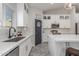 Beautiful kitchen with white cabinets, quartz countertops, stainless steel appliances, and a view to the backyard at 4446 W Kimberly Way, Glendale, AZ 85308