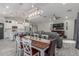 Open-concept living and dining area boasts modern lighting, comfortable seating, and a seamless flow at 4446 W Kimberly Way, Glendale, AZ 85308