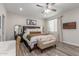 Bright main bedroom featuring a ceiling fan, a bench, and a large window for plenty of natural light at 4446 W Kimberly Way, Glendale, AZ 85308