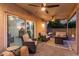 Relaxing covered patio complete with ceiling fans, comfortable seating, and a cozy backyard at 4446 W Kimberly Way, Glendale, AZ 85308