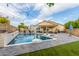 Outdoor pool area features a basketball hoop, outdoor seating and string lights, providing the perfect space for relaxation and entertainment at 4446 W Kimberly Way, Glendale, AZ 85308