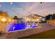 This backyard pool area at twilight, complete with waterfall, offers a relaxing place to unwind after the sun goes down at 4446 W Kimberly Way, Glendale, AZ 85308