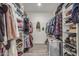 Organized walk-in closet with shelves and hanging rods for storage of clothes, shoes, and accessories at 4446 W Kimberly Way, Glendale, AZ 85308