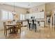 Eat-in kitchen features white cabinets, stainless steel appliances, a kitchen island, and tile flooring at 4515 E Casey Ln, Cave Creek, AZ 85331