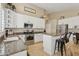 Kitchen showcasing a range with stainless steel appliances, granite counters, and white cabinets at 4515 E Casey Ln, Cave Creek, AZ 85331