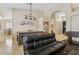 An interior view showcases the living room with tiled flooring, an archway, and an oversized leather sofa at 4515 E Casey Ln, Cave Creek, AZ 85331