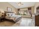 Spacious bedroom featuring a ceiling fan, tile flooring, and backyard views at 4515 E Casey Ln, Cave Creek, AZ 85331