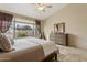 Bright bedroom with large window, vaulted ceilings, tile floors, ceiling fan, and backyard views at 4515 E Casey Ln, Cave Creek, AZ 85331