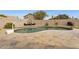 Backyard pool with custom stone patio, lounge seating, and a basketball hoop for outdoor enjoyment at 4515 E Casey Ln, Cave Creek, AZ 85331