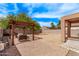 Expansive backyard features a pergola, brick pavers, and ample space for outdoor activities at 45574 W Tulip Ln, Maricopa, AZ 85139