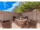 Backyard fire pit area with a brick surround and comfortable seating for outdoor gatherings at 45574 W Tulip Ln, Maricopa, AZ 85139