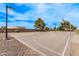 Community basketball court with clear blue skies, perfect for a friendly game at 45574 W Tulip Ln, Maricopa, AZ 85139
