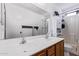 Bright bathroom featuring a double sink vanity, large mirror and shower at 45574 W Tulip Ln, Maricopa, AZ 85139