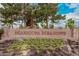 Community entrance sign for Maricopa Meadows, surrounded by lush greenery at 45574 W Tulip Ln, Maricopa, AZ 85139