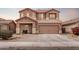 Two-story home boasts a two-car garage, a cozy front porch and low-maintenance landscaping at 45574 W Tulip Ln, Maricopa, AZ 85139