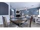 Cozy eat-in dining area flows into a living space with a fireplace and large sectional sofa at 45574 W Tulip Ln, Maricopa, AZ 85139