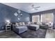 Bright living room with large sectional sofa, stylish decor, hardwood floors and recessed lighting at 45574 W Tulip Ln, Maricopa, AZ 85139