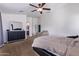 Spacious main bedroom features a large bed, dresser, and cozy seating area at 45574 W Tulip Ln, Maricopa, AZ 85139