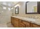 Bathroom featuring dual sinks, granite countertops, and tile and glass shower at 4718 E Woburn Ln, Cave Creek, AZ 85331