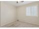 This bedroom features neutral walls and carpet, with a bright window dressed with stylish white shutters at 4718 E Woburn Ln, Cave Creek, AZ 85331