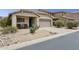Inviting single-story home with desert landscaping, covered porch, and two-car garage at 4718 E Woburn Ln, Cave Creek, AZ 85331